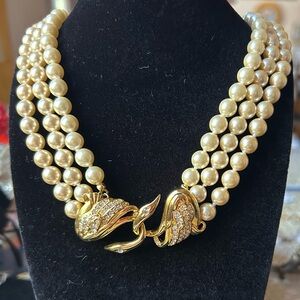 Vintage faux 3 strand peal necklace.
Approx 26" long. designer: Uksana